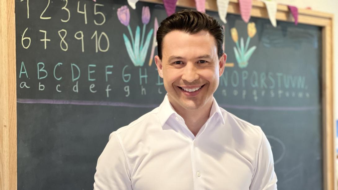 Luis E. García de Brigard stands in front of a chalkboard